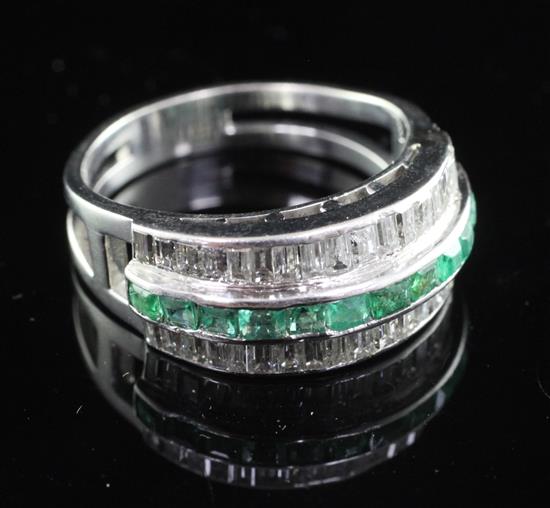 A white gold channel set emerald and diamond ring, size R.